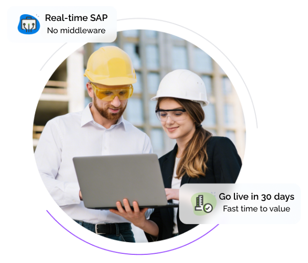 Two manufacturing professionals reviewing data on a laptop, representing real-time SAP integration and system uptime.