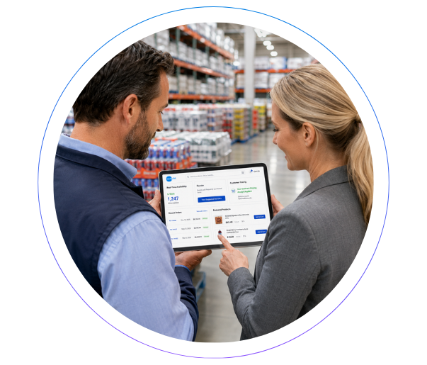 Two manufacturing professionals reviewing data on a laptop, representing real-time SAP integration and system uptime.